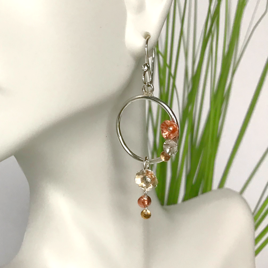 Dangling silver hoop earrings with flowers made of copper and silver